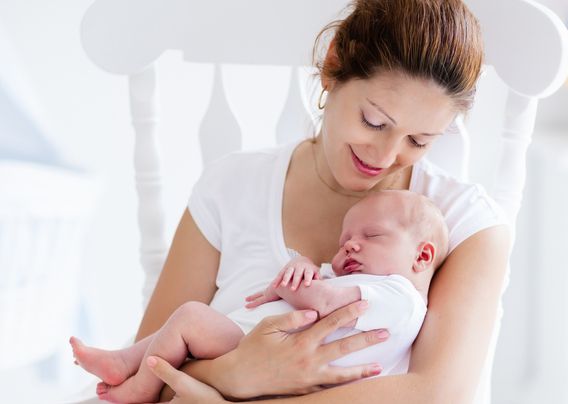 mother holding sleeping baby